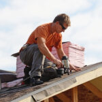Roofing contractor working on roof