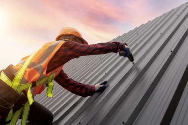 A man completes a commercial roofing project