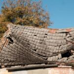 A tile roof is so damaged that it's sinking into a house